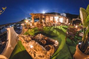 an outdoor patio with a large tree stump on top of a house at Katerina apartments in Néos Pírgos