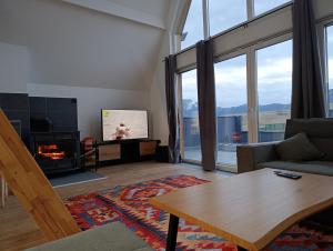 a living room with a couch and a fireplace at Peak Vista A-Frame in Sarajevo