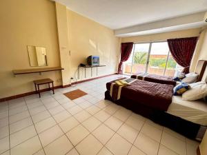 una stanza d'albergo con un letto e una finestra di ระยองบีช Rayong Beach Hotel a Ban Chak Phai