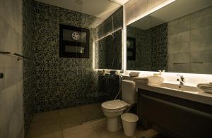 a bathroom with a toilet and a sink and a mirror at Travelholic New Cairo Residence in Cairo +20 photos