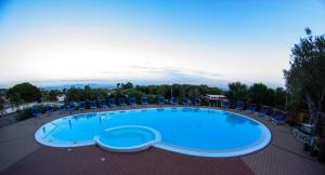 a large swimming pool with chairs at Park Hotel Cilento in Marina di Camerota