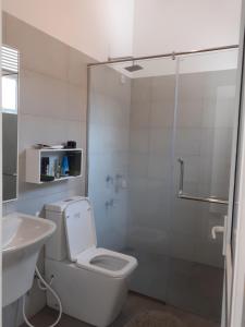 a bathroom with a shower and a toilet and a sink at Sathmani in Pallekele Kadawidiya +30 photos
