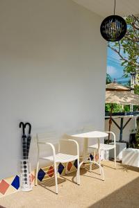 a table and chairs and a table and a table at Peridot Pool Beach in Chaweng Noi Beach