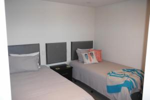 A bed or beds in a room at The Sands