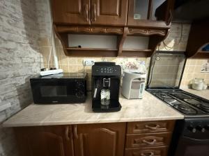 a kitchen with a coffee maker on a counter at 1 комната для 2х человек центр парк in Chişinău