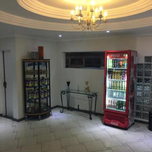 a coca cola refrigerator in a room with a table at Smart Hotel in Registro