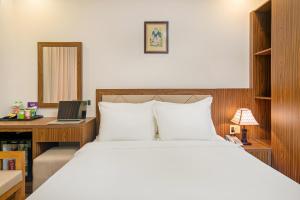 Postel nebo postele na pokoji v ubytování De Lamour Hotel Da Nang