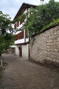 a stone building next to a stone wall at Turgut Reis Konak in Safranbolu