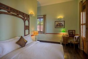 En eller flere senge i et værelse på Le Relais de Chhlong + 33 billeder