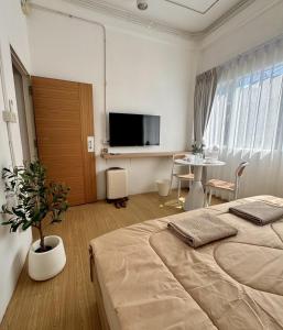 a bedroom with a large bed and a table at Chatuchak Haus in Bangkok