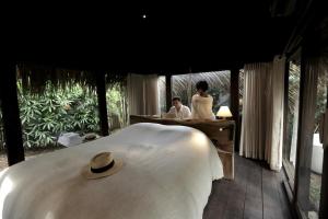 a man and woman sitting at a desk in a bedroom at Sadela Retreat in Ấp Câm Sơn (2)