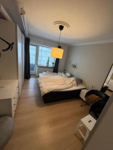 a bedroom with a bed and a desk and a lamp at 120 m2 newly renovated apartment in Copenhagen