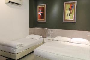 Postel nebo postele na pokoji v ubytování M Design Hotel @ Seri Kembangan
