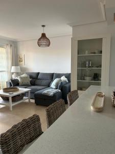 a living room with a couch and a table and chairs at Apartment Duquesa Fairways/Manilva, Spain in Manilva