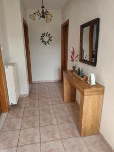 a hallway with a table and a mirror on the wall at Portitsa View Guesthouse in Spílaion +28 photos