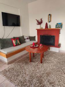 a living room with a couch and a coffee table at Portitsa View Guesthouse in Spílaion