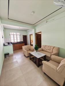 a living room with couches and a table at Kaizen Stay-Inn in Jowai