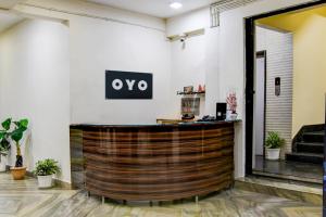 a hotel lobby with a large wooden bar at Hotel O MAJESTIC M2 INN in New Town