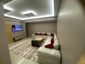 a living room with a couch and a tv at Casablanca City-Centre Apartment in Casablanca