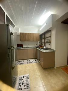 a kitchen with a refrigerator and a tile floor at Casablanca City-Centre Apartment in Casablanca