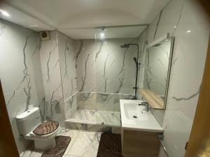 a bathroom with a toilet and a sink at Casablanca City-Centre Apartment in Casablanca +3 photos