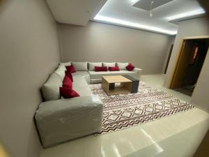a living room with a couch and a coffee table at Casablanca City-Centre Apartment in Casablanca