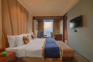 a hotel room with a bed and a television at BluSalzz Residence Amritsar in Amritsar