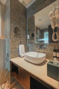 a bathroom with a large white bowl sink on a counter at BluSalzz Residence Amritsar in Amritsar