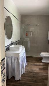 a bathroom with a sink and a toilet at El Corral de Tía Gloria in Pepino +32 photos