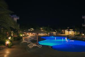 a swimming pool at night with blue water at Sheikh Ali Dahab Resort in Dahab +29 photos