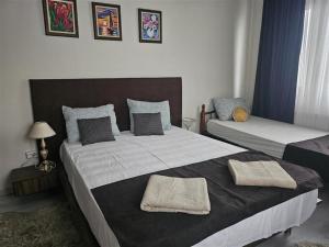 a bedroom with two beds with towels on them at Бадевски рай-къща Надежда in Badewzi +41 photos