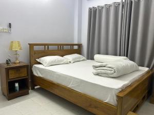 En eller flere senge i et værelse på Sribhumi Homestay Sreemangal