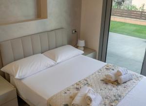 a bedroom with a bed with towels on it at Villa Giuseppe Seaside in Lido Di Fondi