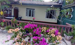 a garden with flowers in front of a house at Sanasuma Villa in Bentota
