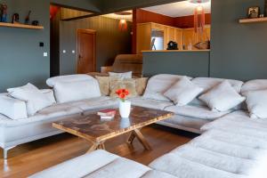 a living room with white couches and a coffee table at K Ardamis Estate in Kastoria