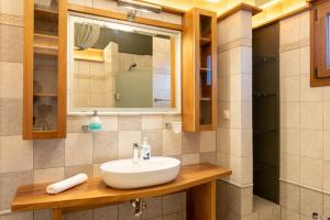 a bathroom with a sink and a mirror at K Ardamis Estate in Kastoria +34 photos