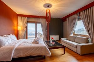 a bedroom with a bed and a couch and a table at K Ardamis Estate in Kastoria