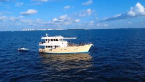 a white boat in the middle of the ocean at Ocean Pearl in Filitheyo
