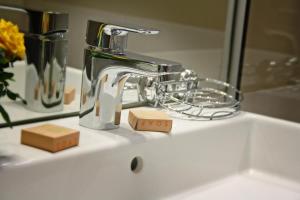 a bathroom sink with a faucet and a wooden cube at Nemo in Brăila
