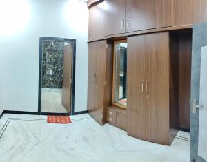 an empty room with wooden cabinets and a mirror at Nature Escape Villa in Jodhpur