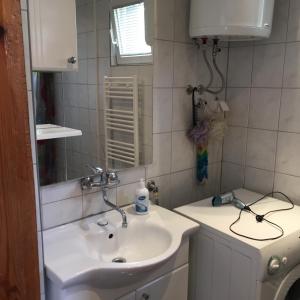 a bathroom with a sink and a mirror at Feel like home guest house in Sarajevo +32 photos