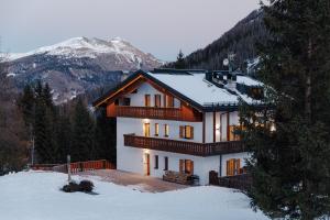 een huis bovenop een met sneeuw bedekte berg bij Appartamento Piz Boe' in Arabba