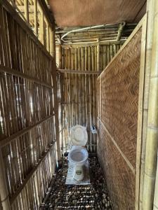 a bathroom with a toilet in a wooden stall at Lagom Village-Glamping Site- Đồng Đò lake view in Hanoi