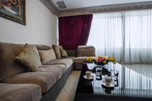 a living room with a couch and a table at Sara Palace Apartments- family only in Kuwait