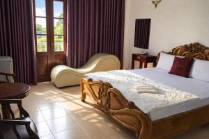a bedroom with a large bed and two chairs at Du Thuyền Hotel Hồ Chí Minh in Ho Chi Minh City +20 photos