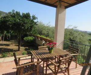 a wooden table and chairs on a patio at casa verdemare in Cefalù