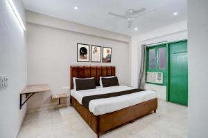 een slaapkamer met een bed en een groen raam bij Collection O by OYO HOTEL DLF PHASE-4 MG ROAD in Gurgaon