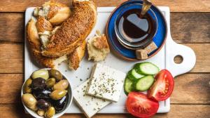 a plate of food with bread and a cup of coffee at Ali Baba Butik Otel in Gündoğdu +43 photos