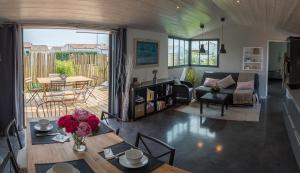 a living room with a table and a couch at Maison d'Hôtes Les Petites Terres in Sainte-Marie-de-Ré