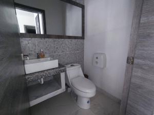 a bathroom with a toilet and a sink and a mirror at Apartment in Same, Casa Blanca in Súa +5 photos
